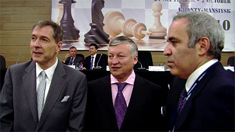 Richard Conn, a dapper Anatoly Karpov and Garry Kasparov on the floor during the FIDE Assembly. FIDE's Nigel Freeman and Kirsan Ilyumzhinov at the head table. Ilyumzhinov would win another term as FIDE President. Photo by Europe-Echecs.com.
